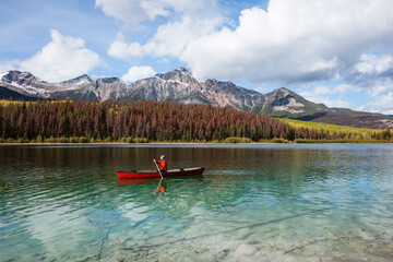 Man canoeing on lake, Jasper National Park, Canada