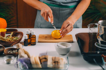 Woman Cutting Lemon for Homemade Soap