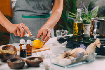 Fototapeta na wymiar Woman Cutting Lemon for Homemade Soap