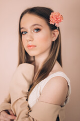 Fashion girl portrait in studio with flowers