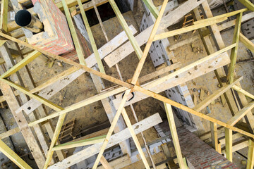 Aerial view of a private house with aerated concrete brick walls and wooden frame for future roof.