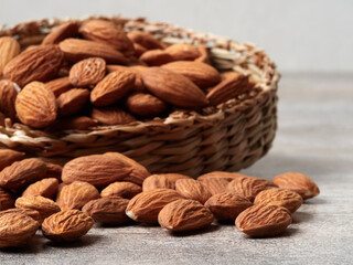 Almond in a bowl on wooden background with copy space