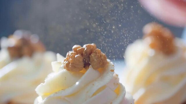 Decorating cupcakes with food gold dust.