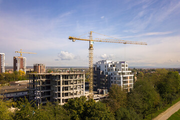 Aerial view of high residential apartment buildings under construction. Real estate development.