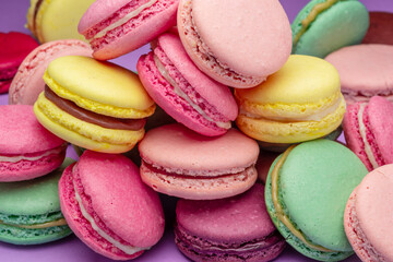 Colorful sweet macarons or macaroons, flavored cookies close-up.