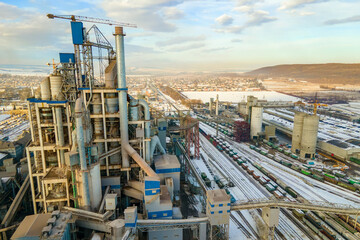 Fototapeta na wymiar Aerial view of cement plant with high factory structure at industrial production area.