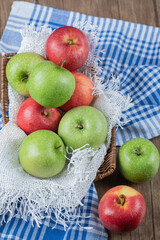 Red and green apples isolated on a blue checked towel