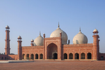 Morning view of ancient sandstone and marble landmark Badshahi mosque built by mughal emperor Aurangzeb in Lahore, Punjab, Pakistan