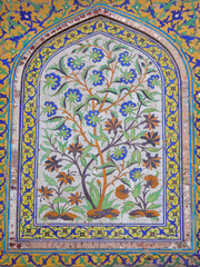 Colorful ancient floral mosaic panel at Shah Burj gate on the entrance arch to Lahore fort, Punjab, Pakistan, a UNESCO World Heritage site
