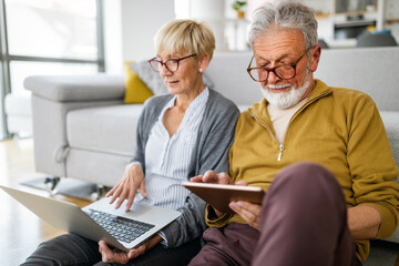 Happy romantic senior couple hugging and enjoying retirement at home