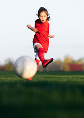 Little girl kicks soccer ball © Dusan Kostic