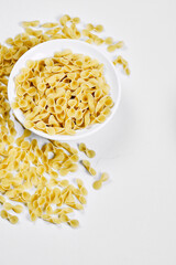 Raw pasta on white background