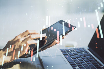 Double exposure of abstract creative financial chart with finger clicks on a digital tablet on...