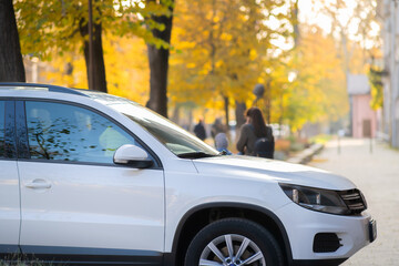 Cars parked on a city street side on pedestrian zone.