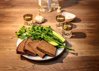 Bread, salt, herbs, cucumbers and vodka shots. Because the neighbor came to visit for a minute