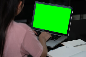 Closeup woman hand using computer laptop. Using online connect technology for business, education and communication. Green screen computer for graphic display montage.