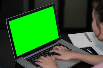 Closeup woman hand using computer laptop. Using online connect technology for business, education and communication. Green screen computer for graphic display montage.