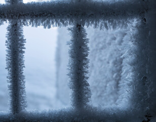 Window grate with snowflakes and hoarfrost in winter
