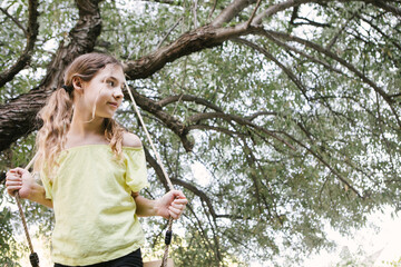 Little girl on a swing in park