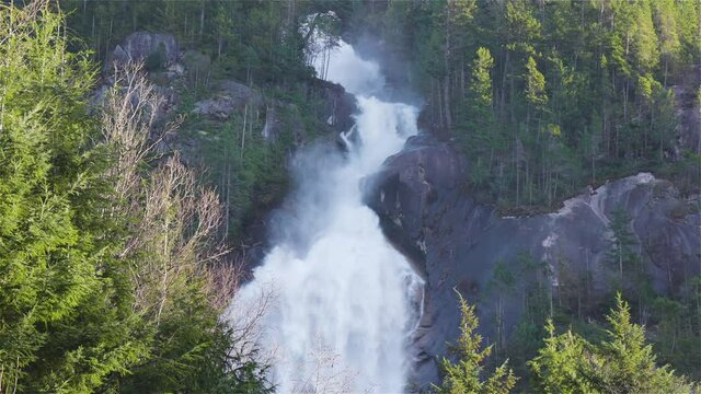 View of Shannon Falls and water rushing down the canyon during a sunny winter day. Located in Squamish, North of Vancouver, British Columbia, Canada. Nature Background Panorama. Slow Motion