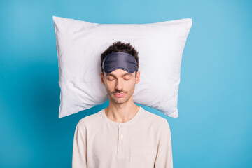 Portrait of nice calm guy sleeping on soft pillow good night isolated over bright blue color...
