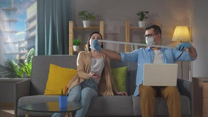 man and a woman keep their distance at home in quarantine humor