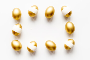 Fototapeta na wymiar Golden eggs isolated on white background. Easter decoration background. Top view
