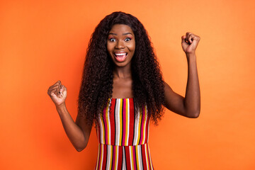 Photo of happy excited cheerful crazy african woman raise fists in victory success isolated on...