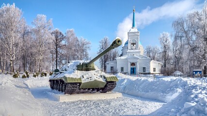 Battle tank in front of orthodox church in Russia.