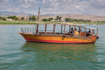 Wooden boats floating on the Sea of Galilee, Israel. Sunny day on Kinneret