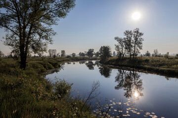 Dawn over a misty lake in spring