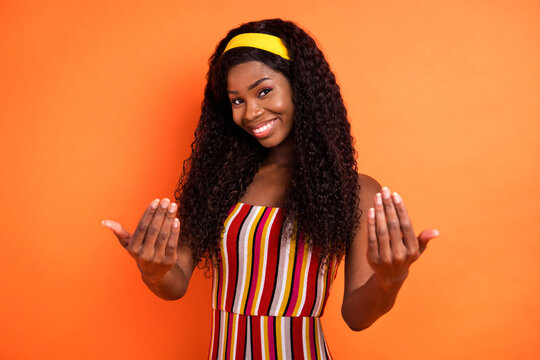 Photo of afro american attractive nice lady gesture come here you isolated on orange color background