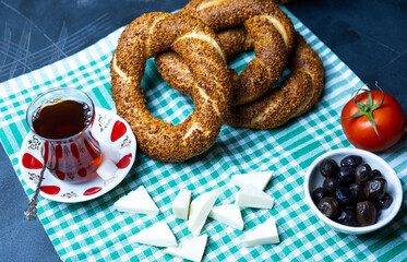 Traditional Turkish breakfast olives, simit, cheese, tea, top view. Bagel is traditional Turkish bakery food
