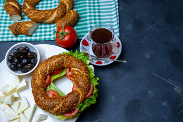 Traditional Turkish breakfast olives, simit, cheese, tea, top view. Bagel is traditional Turkish bakery food
