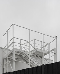 White metal staircase, fire escape from the factory roof, minimalist shot