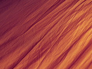 Red abstract wrinkled fabric background with copy space, view from above