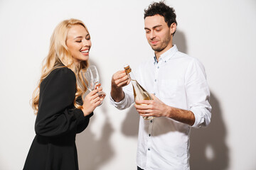 Happy romantic couple smiling while drinking champagne
