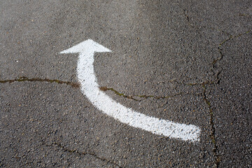arrow sign on asphalt