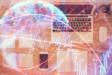 Stock market graph and top view computer on the table background. Multi exposure. Concept of financial education.