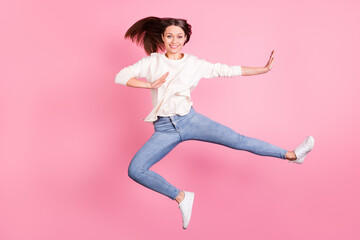 Full length photo of pretty cheerful lady jumping arms show reject symbol isolated on pink color...