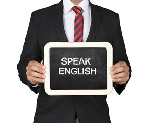A Businessman holding slate mini blackboard with message Speak English