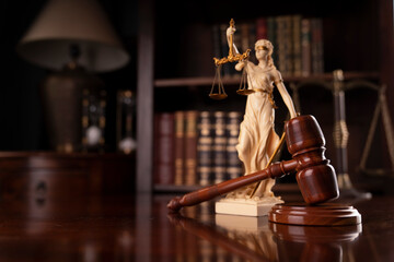 Law theme. Judge chamber. Judge’s gavel, Themis sculpture and collection of legal books on the...