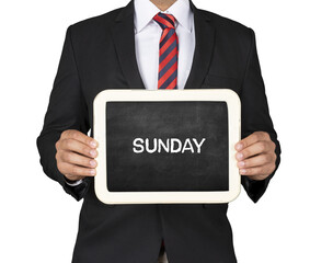  A Businessman holding slate mini blackboard with Sunday message