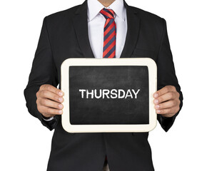 A Businessman holding slate mini blackboard with Thursday message