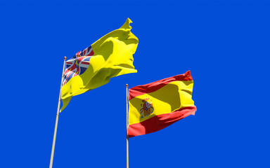 Flags of Niue and Spain.