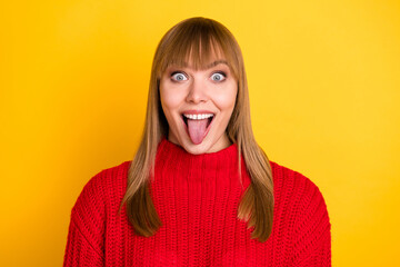 Photo of blond nice optimistic lady tongue out wear red sweater isolated on bright yellow color background