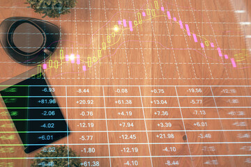 Multi exposure of financial chart hologram over desktop with phone. Top view. Mobile trade platform...