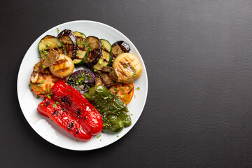 Healthy vegetable grill with brown leather background top view with copy space.