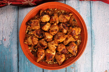 Traditional moroccan tajine of chicken with dried fruits and spices, top view. Moroccan chicken tajine with couscous
