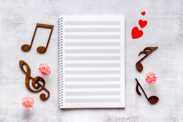 Musical wooden notes on music sheet. Top view